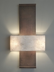 A large architectural wall light Nuit de Chine, by Hannah Woodhouse, is made in aged leather and hand patinated by the artist. The shade is hand made in eucalyptus paper.